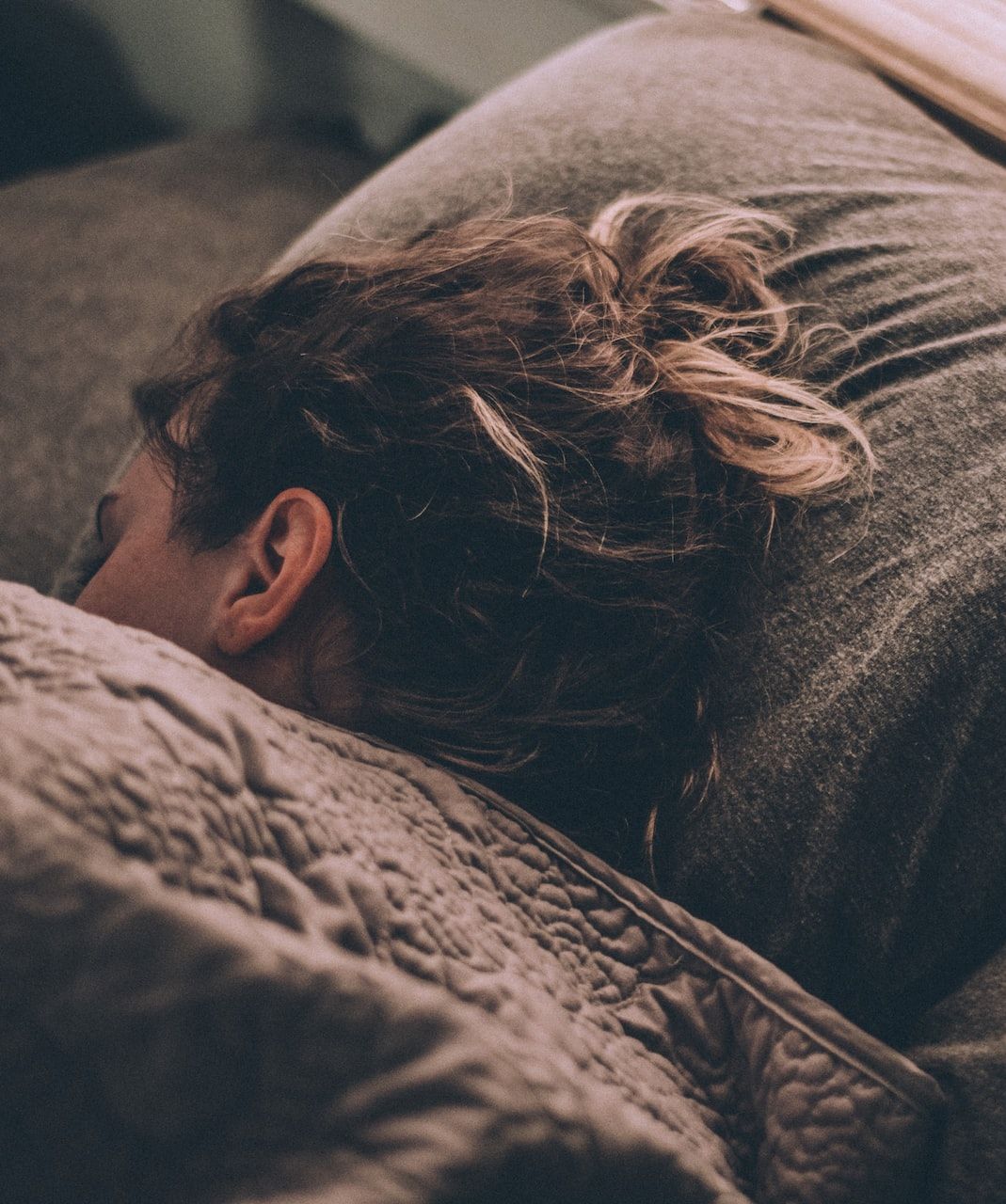 Woman asleep with head on pillow
