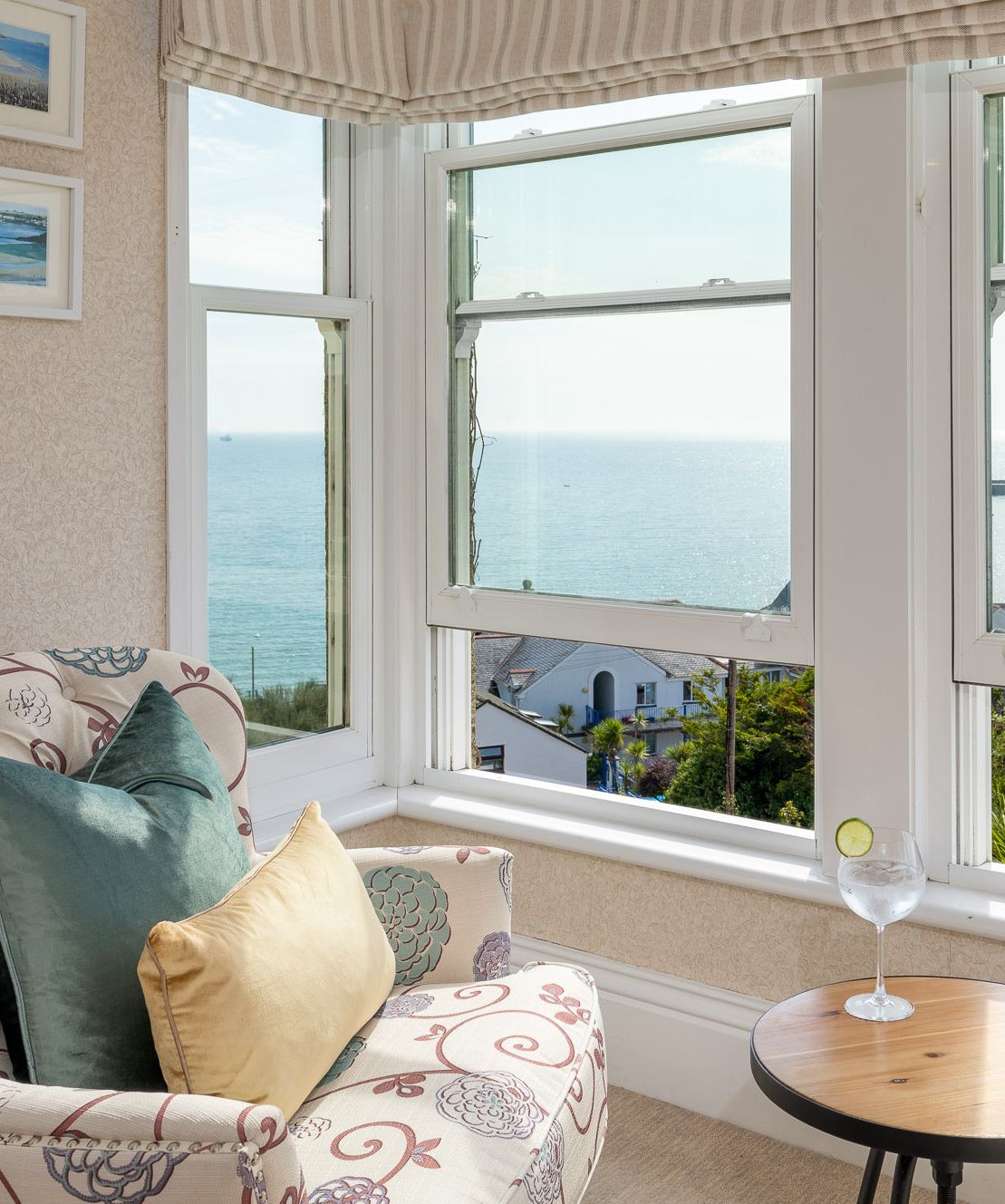 Seaview from window with glass of gin on table