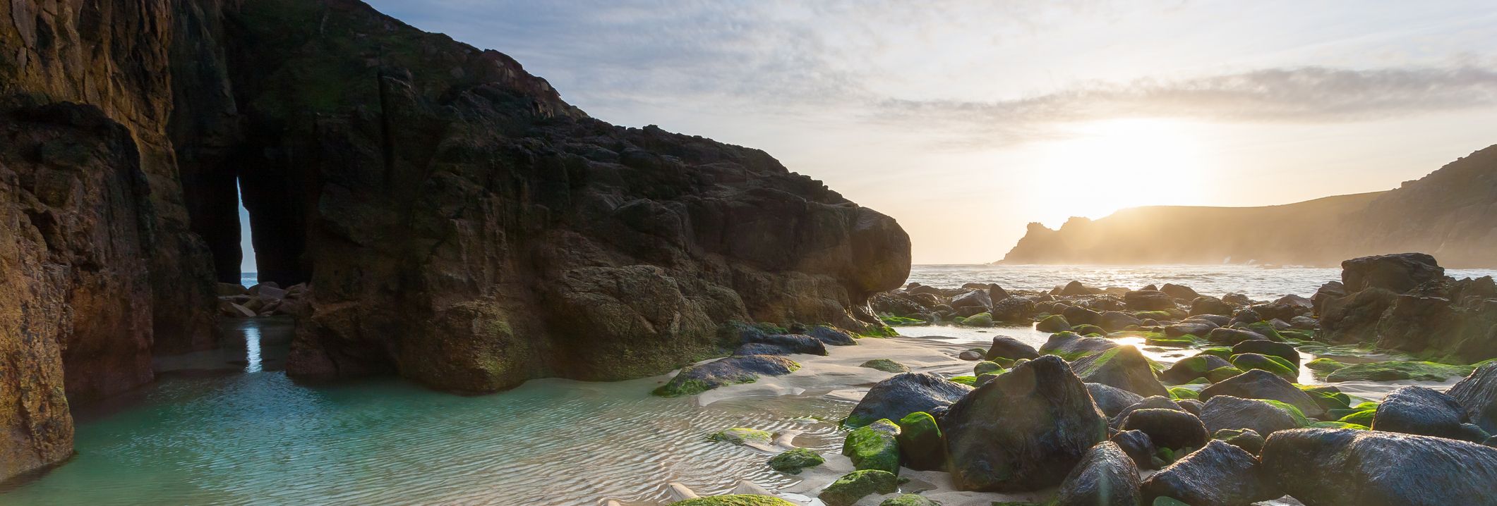 Sunset over rocks on beach