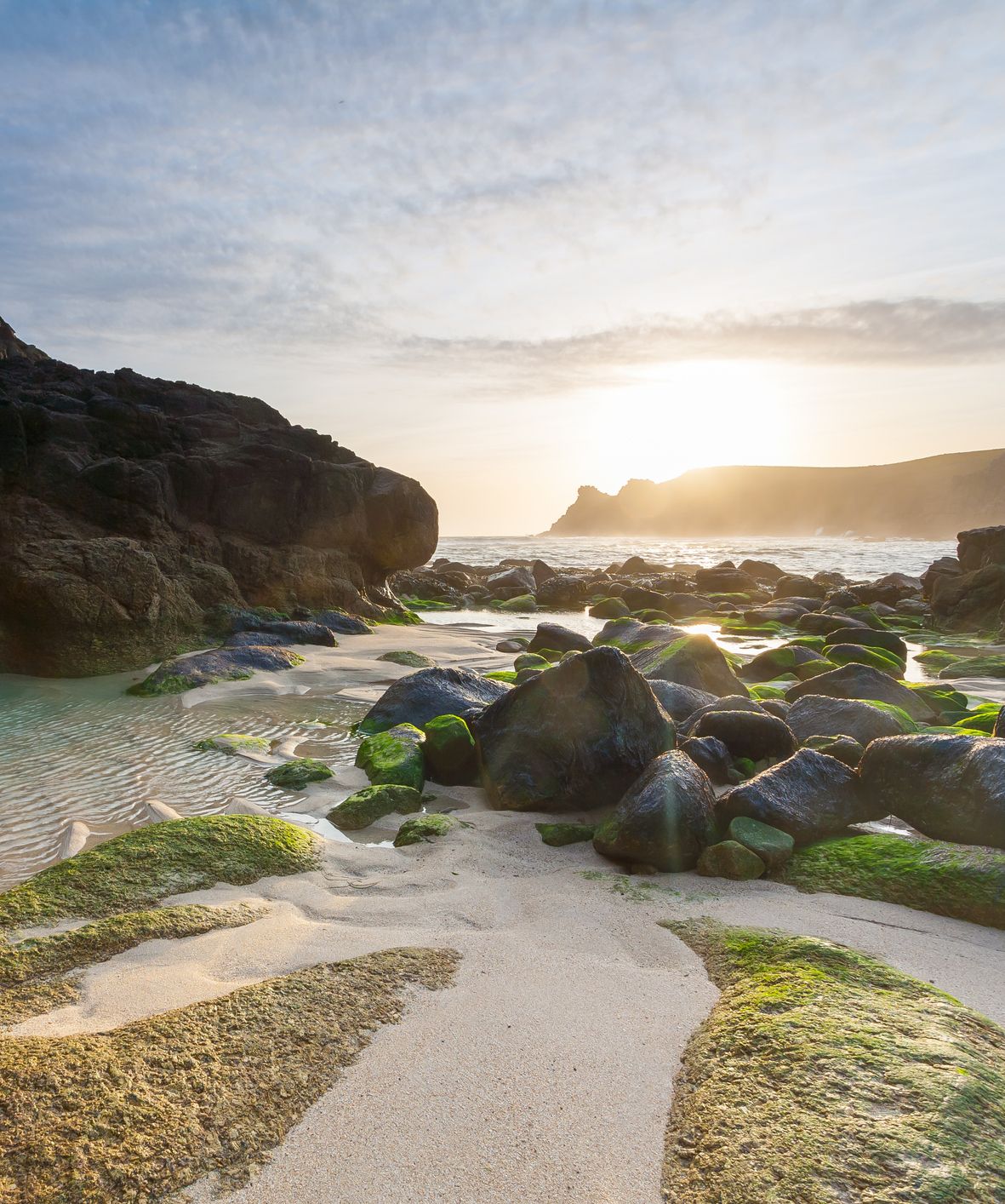 Sunset over rocks on beach