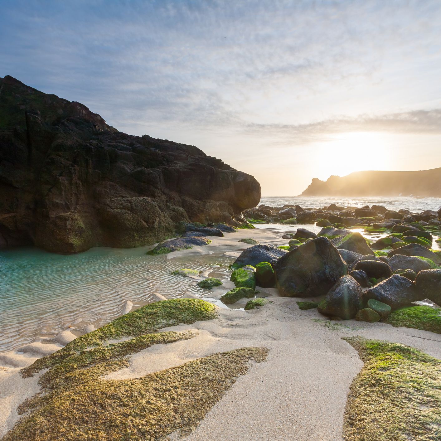 Sunset over rocks on beach