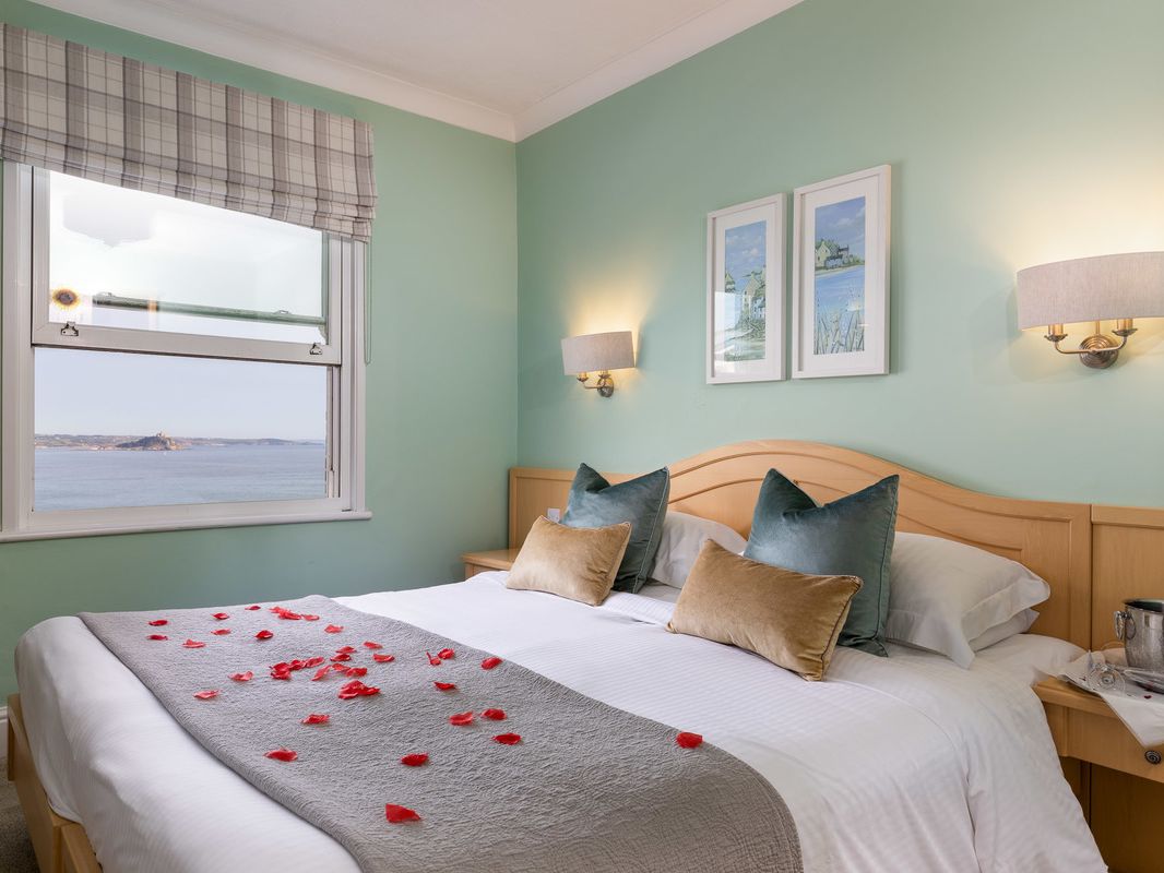 Double bed with rose petals