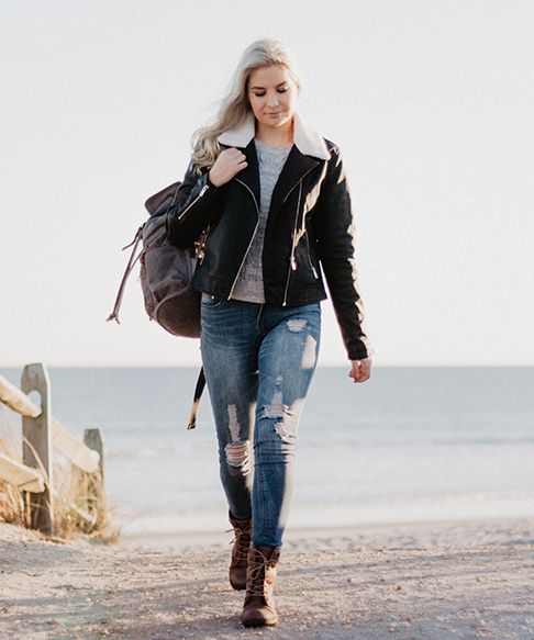 Woman walking up beach path