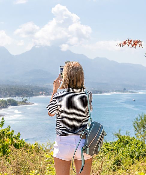 Woman taking photo of view