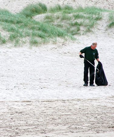 Person litter picking on beach