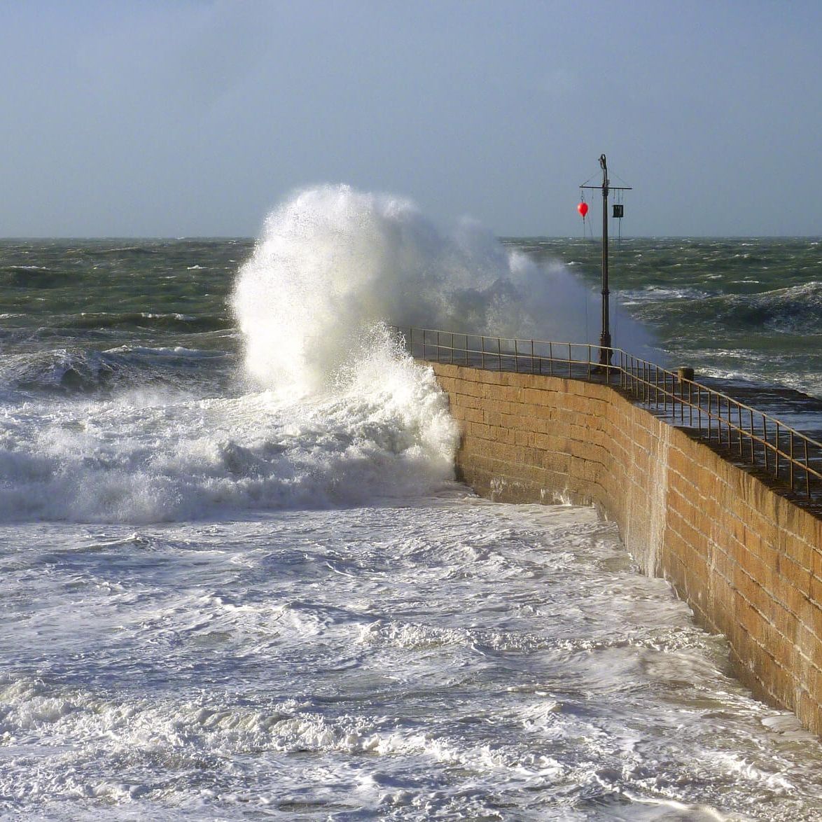Waves crashing into sea wall