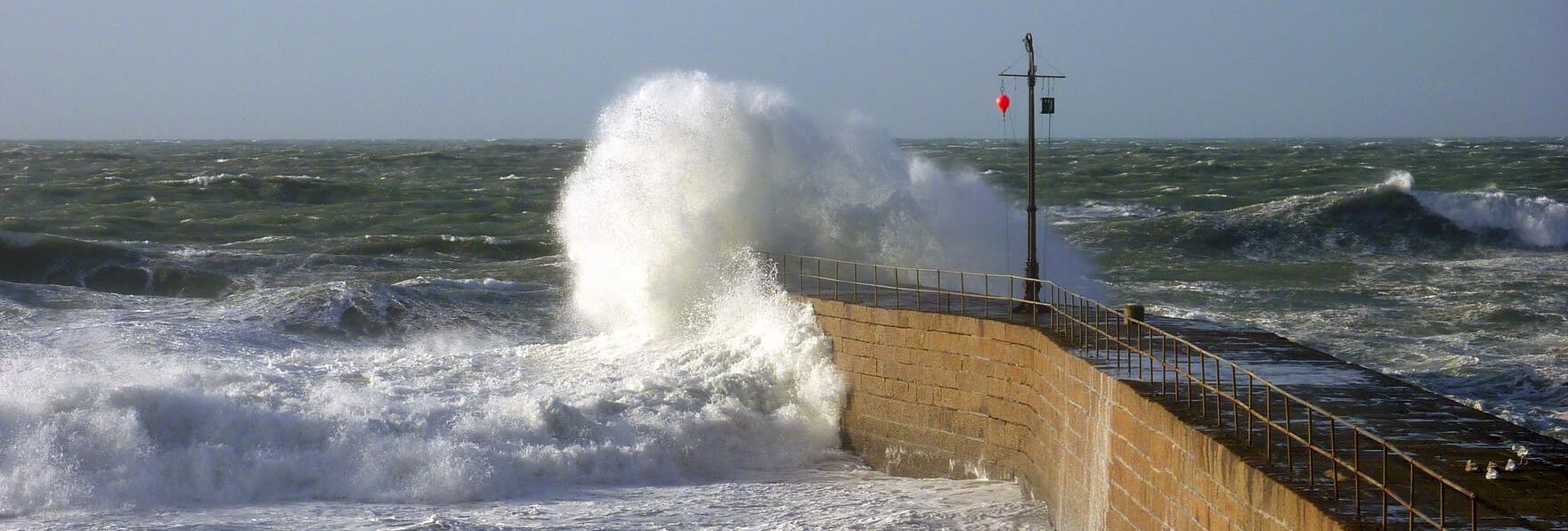 Waves crashing into sea wall