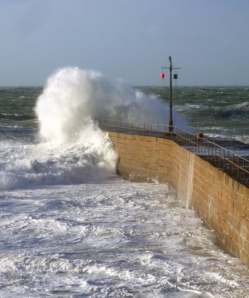 Waves crashing into sea wall