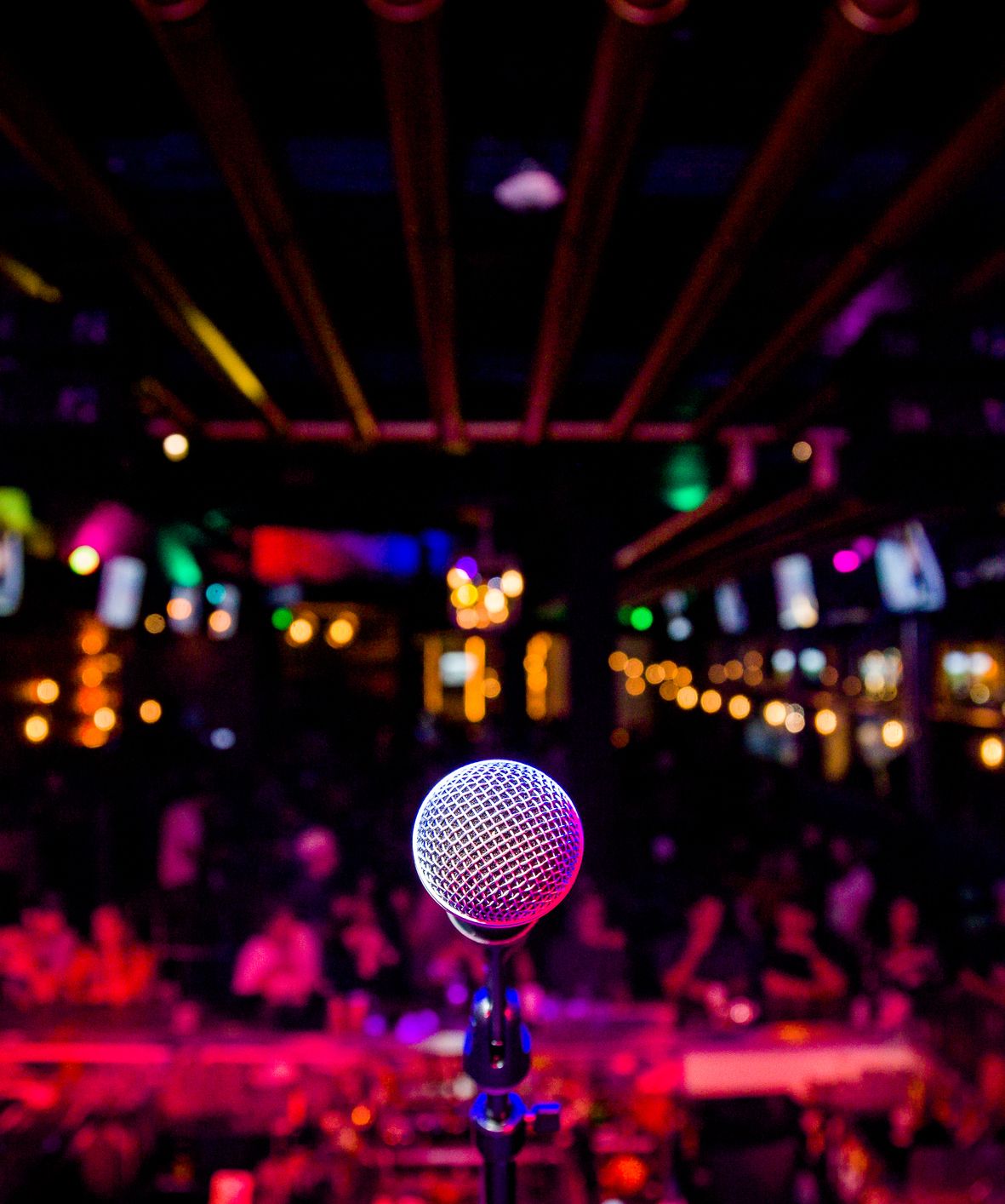 Microphone on stage with lights in background